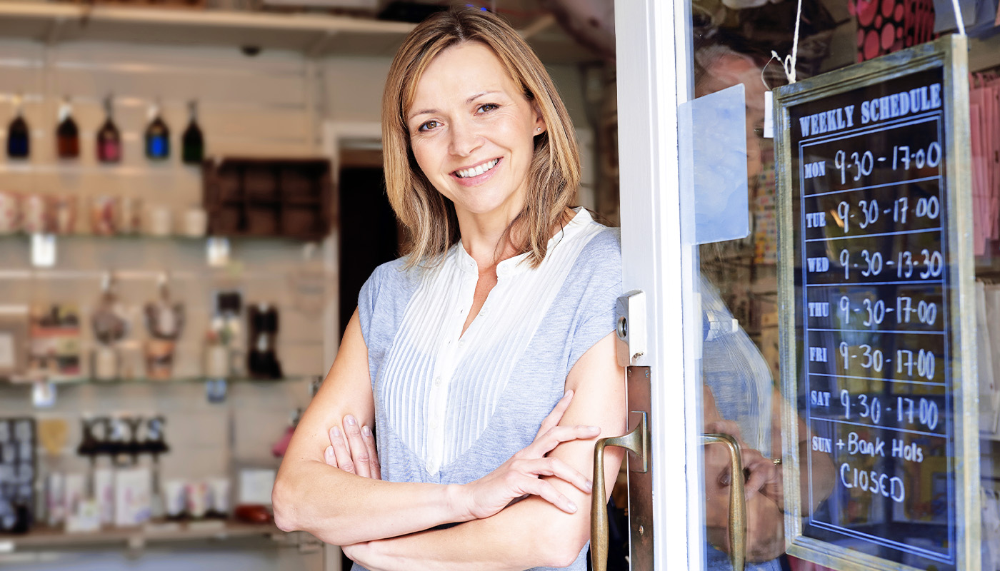 Woman next to her weekly schedule at her business