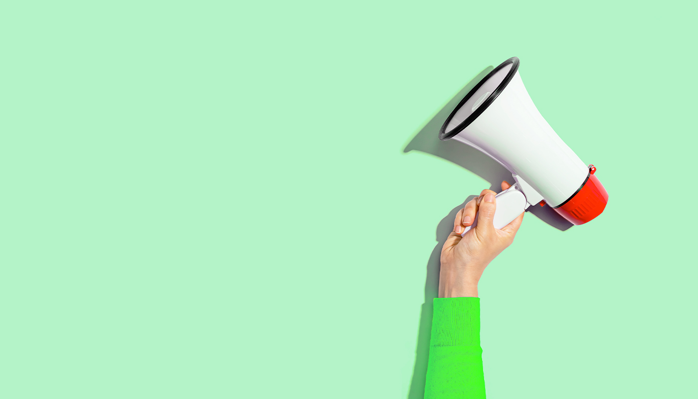 Megaphone on green background