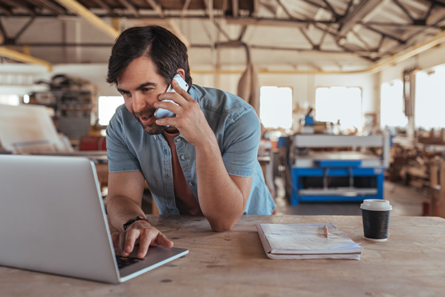 Business owner on phone and computer