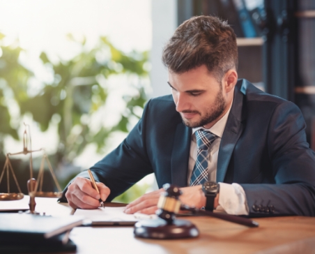 Man signing document at desk