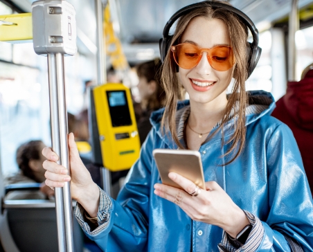 Woman checking phone on a train