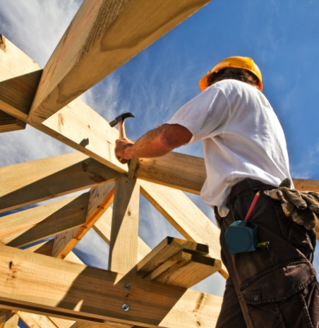 Man working with hammer putting lumber together