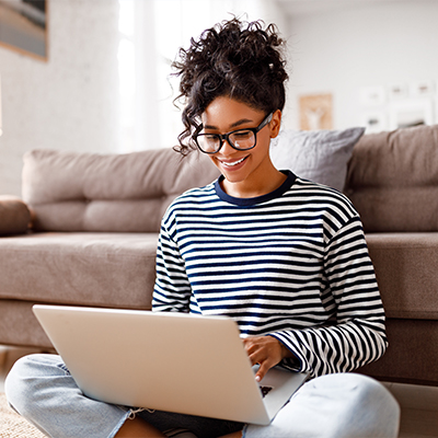 writer on couch with laptop