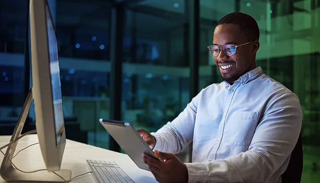 Man working at a computer in the evening