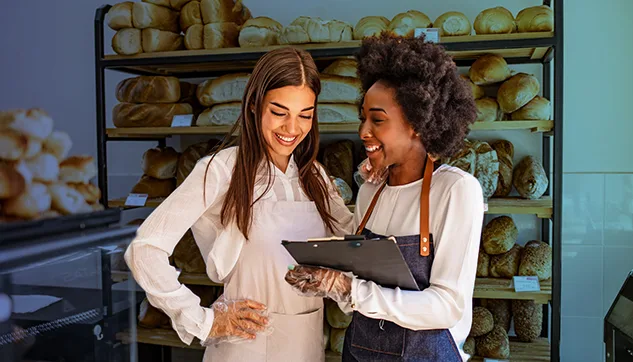 Two women working at a bakery